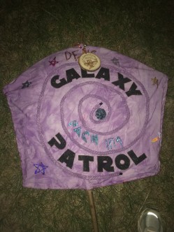Galaxy Patrol The boys created and constructed the shape of the flag, colored the ffabric and rope purple and added their names and other information for their flag competition. They used the front and back of the flag. They won first place in fourth grade competition at Webelos to Scout Expo (WTSE) in Big Cypress District in Cypress Texas.