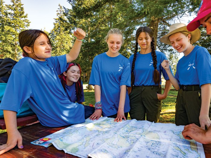 Scouts at a map discussing the days paddle route